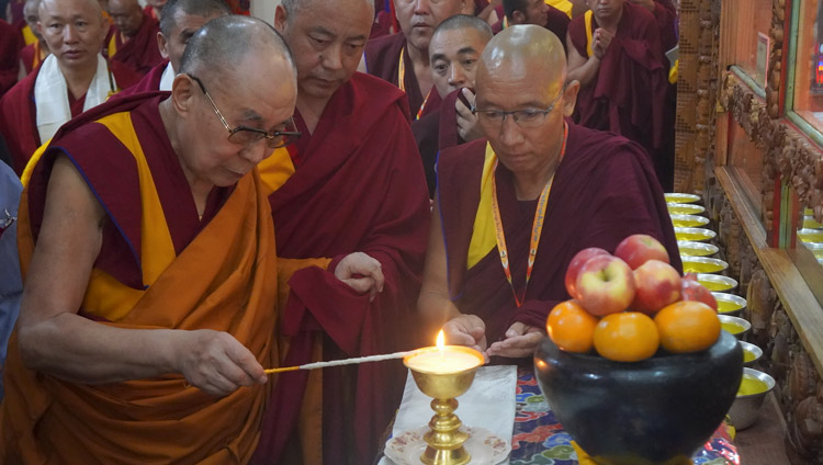 His Holiness the Dalai Lama lighting a lamp before the images of the Buddha in Gaden Lachi Assembly Hall in Mundgod, Karnataka, India on December 20, 2019. Photo by Jeremy Russell