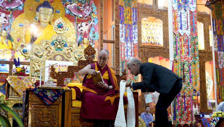 Dr Jinpa offered His Holiness a copy of his newly published biography of Jé Rinpoché after his talk at the International Conference on Jé Tsongkhapa at Gaden Lachi Assembly Hall in Mundgod, Karnataka, India on December 20, 2019. Photo by Lobsang Tsering