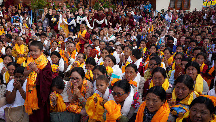 Some of the more than 10,000 people gathered in the yard around Ganden Lachi and Ganden Shartsé Assembly Halls watching as His Holiness the Dalai Lama arrives for the celebration of Ganden Ngamchö in Mundgod, Karnataka, India on December 21, 2019. Photo by Lobsang Tsering