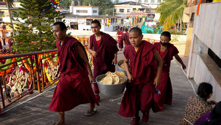 Young monks carry bread to distribute to the over 5,000 people attending the Long Life Offering for His Holiness the Dalai Lama at Gaden Jangtse Monastery in Mundgod, Karnataka, India on December 22, 2019. Photo by Lobsang Tsering