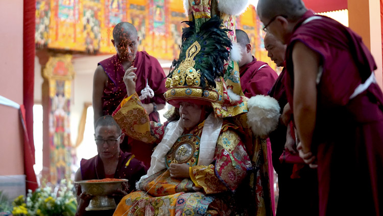 Nechung Oracle tossing blessed barley seeds in the air during the Long Life Offering for His Holiness the Dalai Lama at Gaden Jangtse Monastery in Mundgod, Karnataka, India on December 22, 2019. Photo by Lobsang Tsering