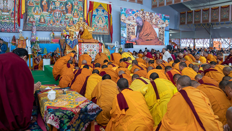 Geshes filling the stage in front of His Holiness the Dalai Lama to get protection from the rain at the Kalachakra Ground in Bodhgaya, Bihar, India on January 3, 2020. Photo by Tenzin Choejor