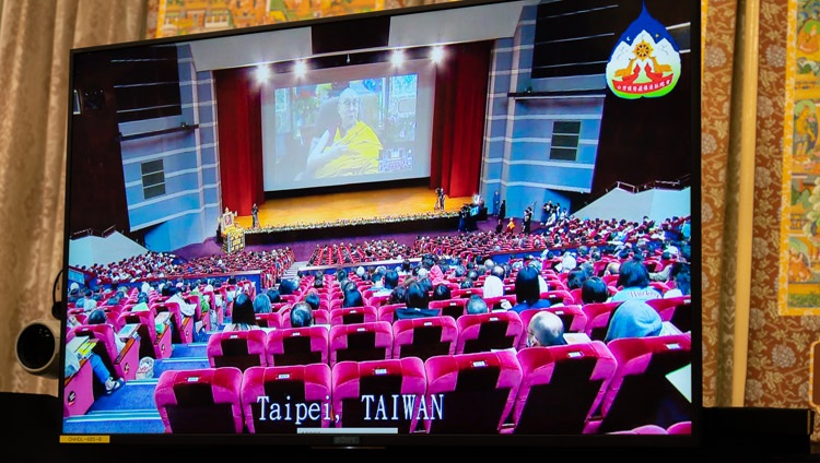 A view of the hall in Taipei shown on one of the TV screens in front of His Holiness the Dalai Lama during the first day of teachings from his residence in Dharamsala, HP, India on October 2, 2020. Photo by Ven Tenzin Jamphel