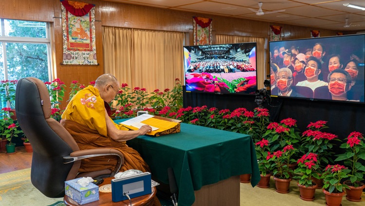 His Holiness the Dalai Lama reading from ‘Illuminating the Threefold Faith: An Invocation of the Seventeen Great Scholar-Adepts of Glorious Nalanda’ during an online program celebrating his having been awarded the Nobel Peace Prize in 1989 from his residence in Dharamsala, HP, India on December 11, 2021. Photo by Ven Tenzin Jamphel