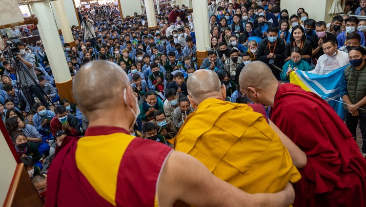His Holiness the Dalai Lama greeting the audience of Tibetan young people as he arrives at the Main Tibetan Temple for the first day of his Teachings for Tibetan Youth in Dharamsala, HP, India on June 1, 2022. Photo by Tenzin Choejor