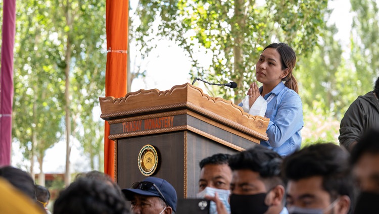 A student from the among the 3000 attending the program at the teaching ground at the Library and Learning Centre at Tiksey Monastery listening to His Holiness the Dalai Lama answer her question in Leh, Ladakh, UT, India on July 25, 2022. Photo by Tenzin Choejor