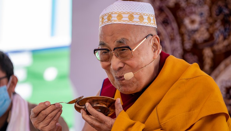 His Holiness the Dalai Lama enjoying a traditional treat during a tea break at his meeting with members of the Muslim community at the Eid Gah in Padum, Zanskar, Ladakh, UT, India on August 13, 2022. Photo by Tenzin Choejor