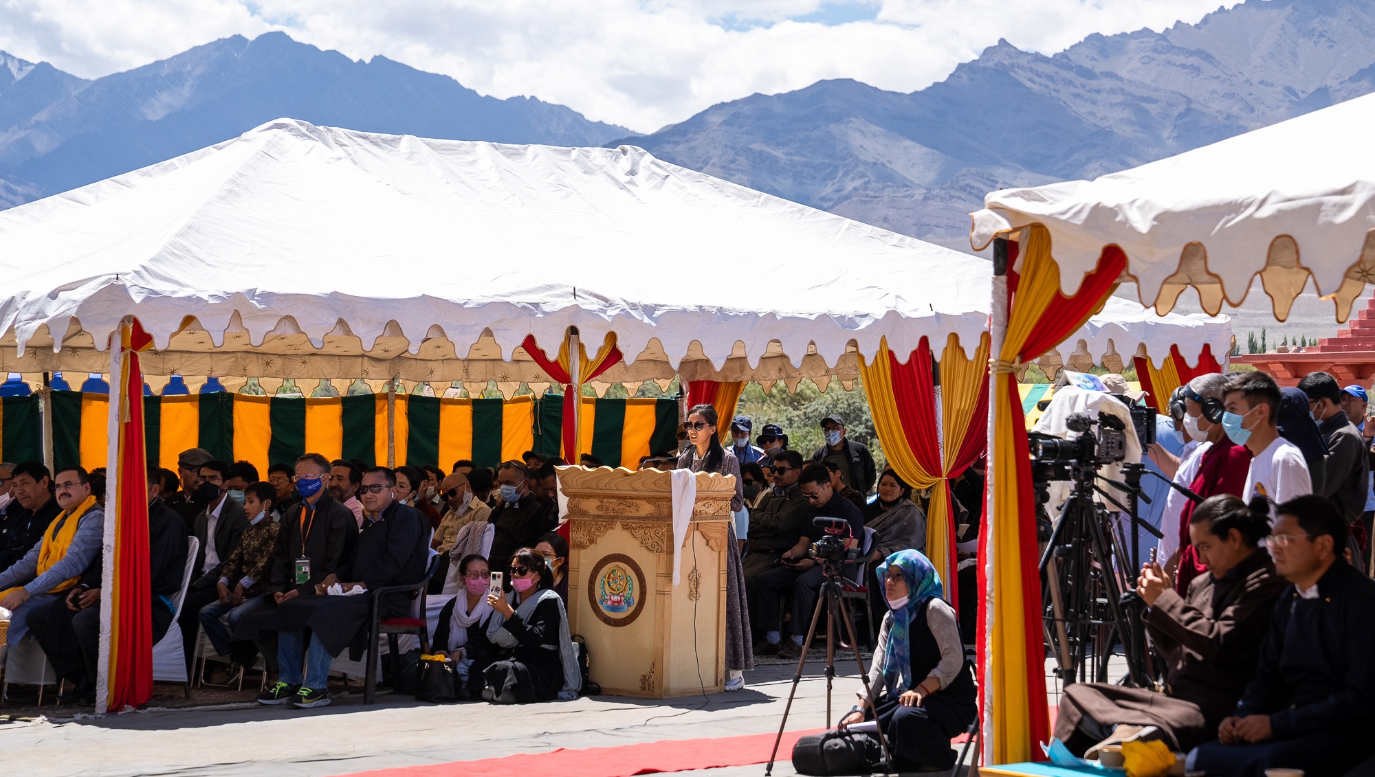 His Holiness the Dalai Lama being introduced to the audience gathered to hear him speak before a luncheon organized by the Ladakh Autonomous Hill Development Council (LAHDC) at Sindhu Ghat in Leh, Ladakh, UT, India on August 23, 2022. Photo by Tenzin Choejor