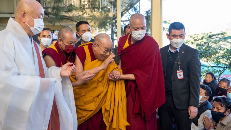 His Holiness the Dalai Lama, accompanied by the Korean Abbot Ven Jungwook Kim, greeting members of the crowd gathered to attend the first day of teachings at the Main Tibetan Temple in Dharamsala, HP, India on November 25, 2022. Photo by Tenzin Choejor