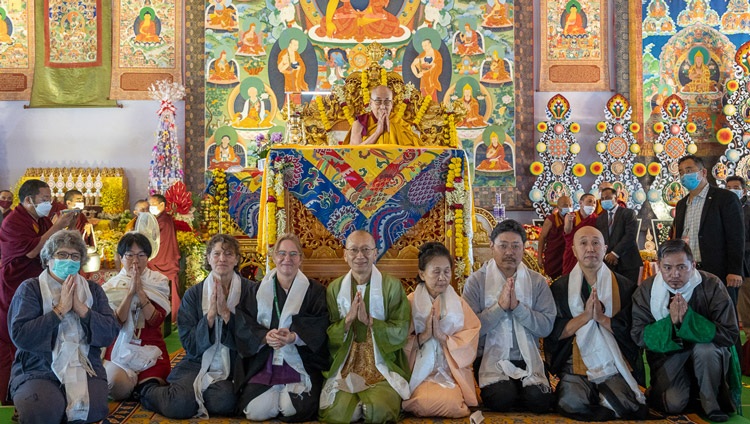 Representatives of the project 'Flame of Hope' posing for a photo with His Holiness the Dalai Lama after presenting him with a lantern which had been lit from the flame of peace in Hiroshima on the second day of teachings in Bodhgaya, Bihar, India on December 30, 2022. Photo by Tenzin Choejor