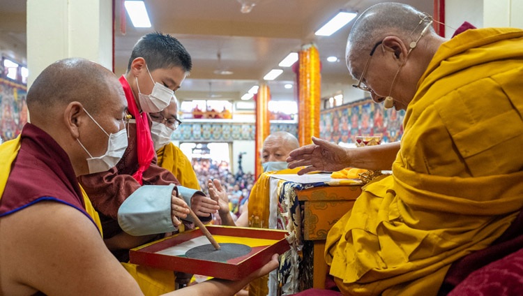 The reincarnation of Khalkha Jetsun Dhampa Rinpoché of Mongolia throwing a tooth stick as part of the Preliminary Procedures for the Chakrasamvara Empowerment at the Tsuglagkhang in Dharamsala, HP, India on March 8, 2023. Photo by Tenzin Choejor