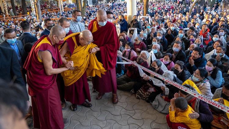 His Holiness the Dalai Lama greeting a young child as he walks to the Tsulagkhang to bestow the Chakrasamvara Empowerment in Dharamsala, HP, India on March 9, 2023. Photo by Tenzin Choejor