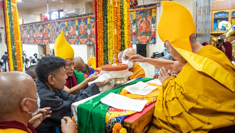 Gaden Tri Rinpoche presenting traditional offerings to His Holiness the Dalai Lama during the Long Life Prayer offered by CTA at the Main Tibetan Temple in Dharamsala, HP, India on March 15, 2023. Photo by Tenzin Choejor