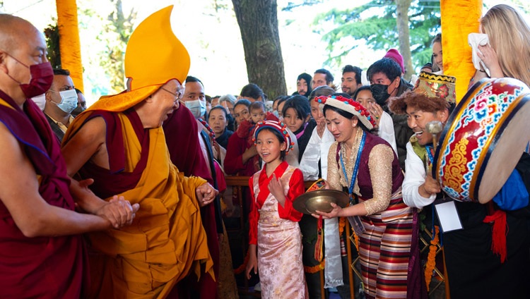 Staff and students of the schools making the Long Life Prayer Offering to His Holiness the Dalai Lama singing as he walks through the Main Tibetan Temple courtyard in Dharamsala, HP, India on April 5, 2023. Photo by Tenzin Choejor