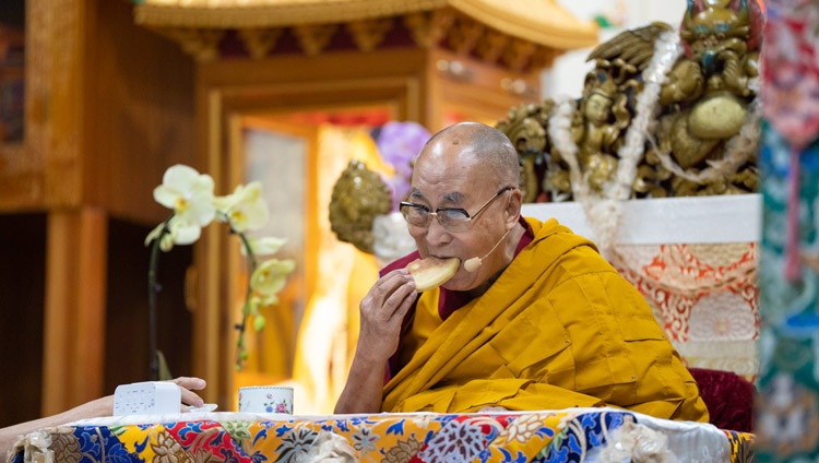 His Holiness the Dalai Lama enjoying some bread on the first day of his teachings for Tibetan Youth at the Main Tibetan Temple in Dharamsala, HP, India on May 30, 2023. Photo by Tenzin Choejor