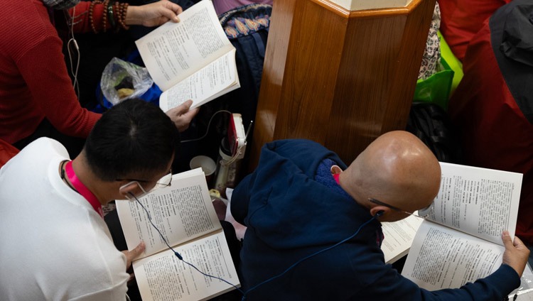 Members of the audience following the text as His Holiness the Dalai Lama reads from Chandrakirti's ‘Entering into the Middle Way’ on the first day of teachings at the request of Southeast Asians at the Main Tibetan Temple in Dharamsala, HP, India on September 5, 2023. Photo by Tenzin Choejor