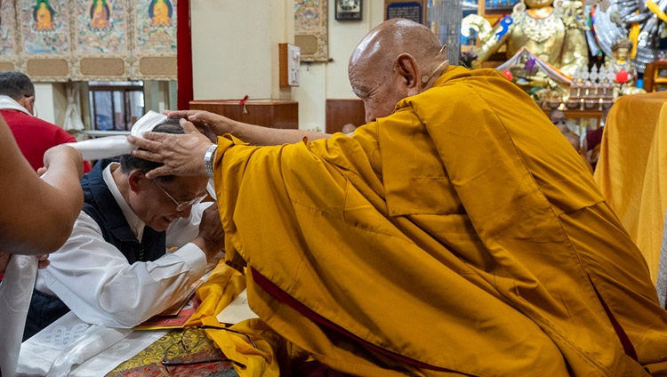 A representative of one of the groups from Taiwan presenting traditional offerings to Gaden Tri Rinpoché at the start of teachings at the Main Tibetan Temple in Dharamsala, HP, India on October 2, 2023. Photo by Tenzin Choejor