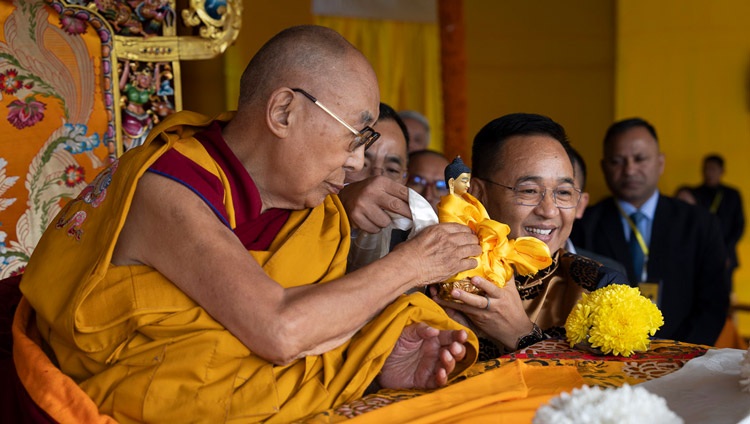 His Holiness the Dalai Lama offering a statue of the Buddha to Sikkim Chief Minister Shri Prem Singh Tamang at the start of teachings at Paljor Stadium in Gangtok, Sikkim, India on December 12, 2023. Photo by Tenzin Choejor