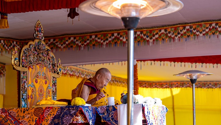 His Holiness the Dalai Lama reading from Gyalsey Thogmé Sangpo’s "37 Practices of a Bodhisattva" during his teaching at Paljor Stadium in Gangtok, Sikkim, India on December 12, 2023. Photo by Tenzin Choejor