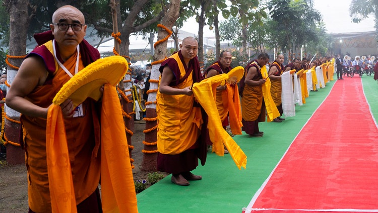 Monks lining the drive at the Kalachakra Ground waiting for His Holiness the Dalai Lama's arrive to attend a Long Life Ceremony in Bodhgaya, Bihar, India on January 1, 2024. Photo by Tenzin Choejor