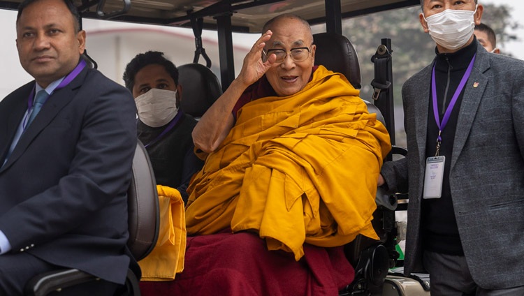 His Holiness the Dalai Lama waving to the crowd as he rides a golf-cart back to the Tibetan Monastery at the conclusion of the Long Life Ceremony at the Kalachakra Ground in Bodhgaya, Bihar, India on January 1, 2024. Photo by Tenzin Choejor