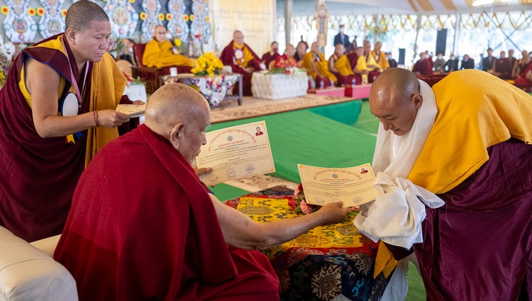 Ganden Tri Rinpoché presenting degrees to the Geshe graduates during the Gelukpa University Convocation and the Award of Geshé Lharampa Degrees at the Kalachakra Ground in Bodhgaya, Bihar, India on January 3, 2024. Photo by Ven Zamling Norbu