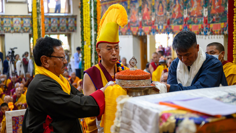 Tenzin, President of The Dhotoe Cholkha Welfare Society, Namgyal Monastery Abbot Lobsang Samten and Jampa Chhiring Lama, President of Lodrik Welfare Assocation, offering a mandala to His Holiness the Dalai Lama during the Long Life Prayers at the Main Tibetan Temple in Dharamsala, HP, India on April 22, 2026. Photo by Ven Zamling Norbu
