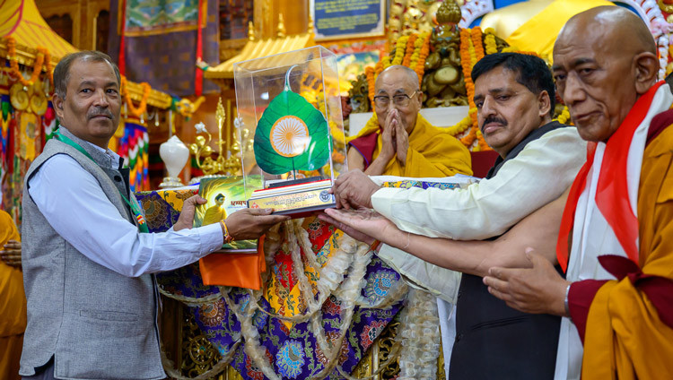 Two lay reprentatives of the Himalayan Buddhist Cultural Association presenting His Holiness the Dalai Lama a mounted ornamental bodhi leaf during the Long Life Prayers at the Main Tibetan Temple in Dharamsala HP, India on May 20, 2026. Photo by Tenzin Choejor