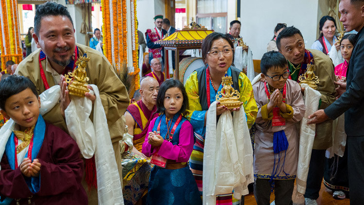 Patrons, along with family members, parading past His Holiness the Dalai Lama holding offerings during the Long Life Prayers at the Main Tibetan Temple in Dharamsala, HP, India on October 21, 2026. Photo by Tenzin Choejor