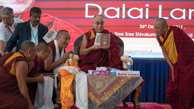 His Holiness the Dalai Lama releasing books produced and published by Sera Jey Monastery before his talk at Tumkur University in Tumakuru, Karnataka, India on December 26, 2017. Photo by Tenzin Choejor