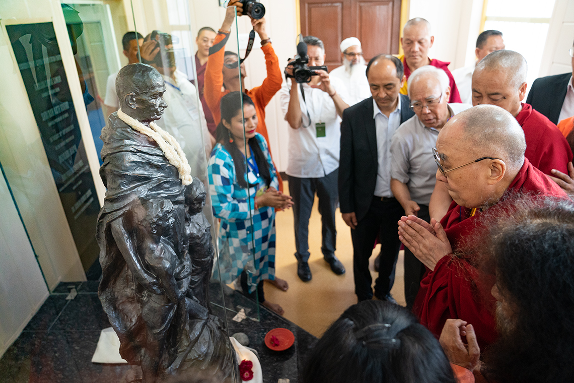 His Holiness the Dalai Lama paying his respects to a statue of Mahatma Gandhi during his visit to the Mahatma Gandhi Library at Gandhi Ashram, Kingsway Camp, New Delhi, India on September 25, 2019. Photo by Tenzin Choejor