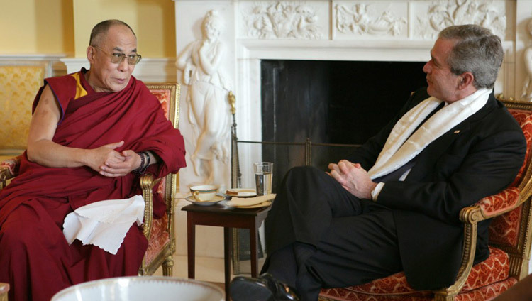 US President George W Bush wearing a scarf that was presented to him by His Holiness the Dalai Lama at the White House in Washington DC, USA on November 9, 2005. (Official White House Photo)