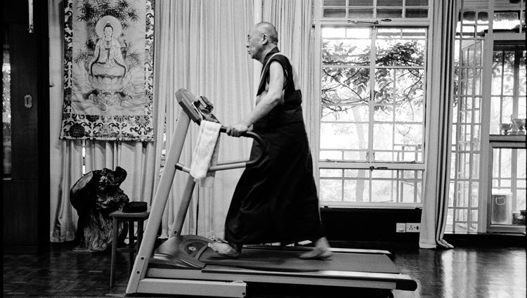 His Holiness the Dalai Lama exercising on his treadmill in his residence in Dharamsala, HP, India on 15 August, 2004. (Photo courtesy of Manuel Bauer)