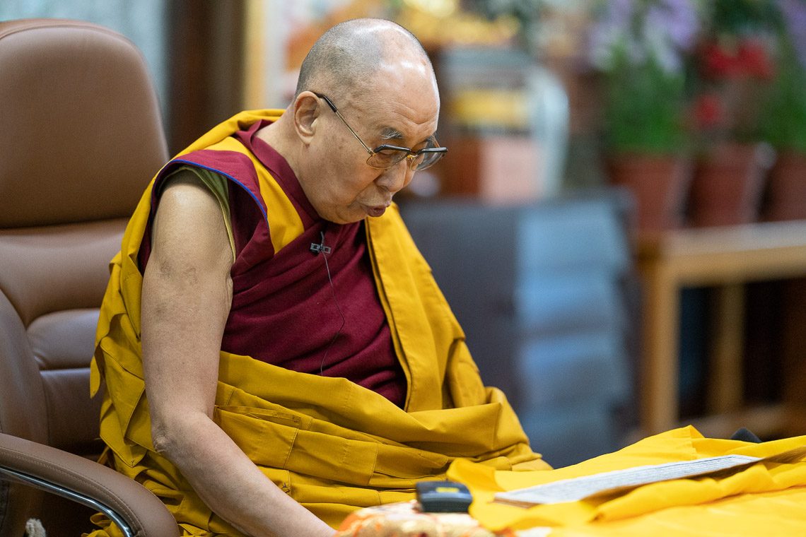 His Holiness The Dalai Lama reading Book