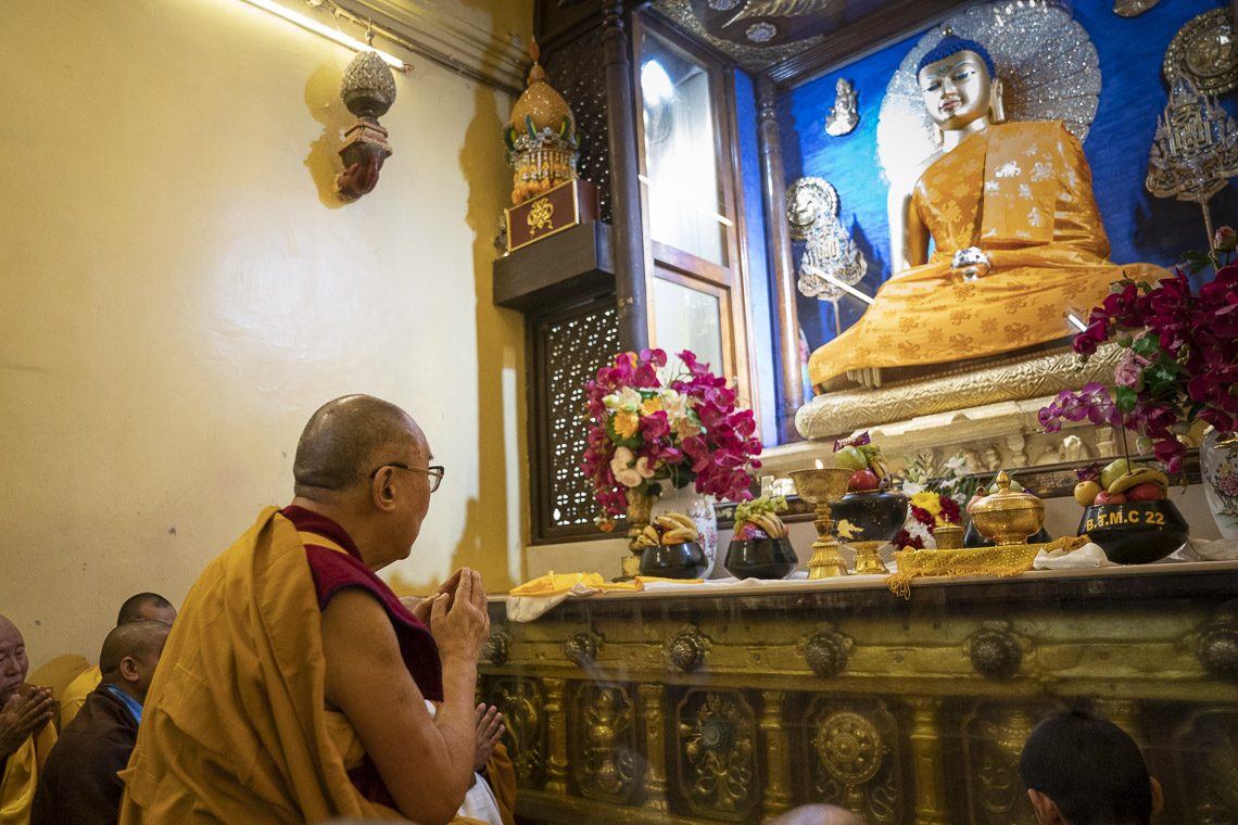 His Holiness The Dalai Lama in front of Buddha.